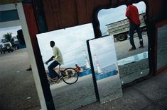 a man riding a bike in front of a mirror