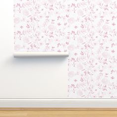 a white wall with pink flowers on it