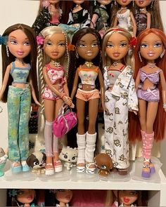 a group of dolls that are sitting on a shelf