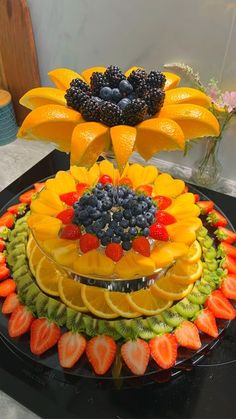 a cake with fruit and flowers on it