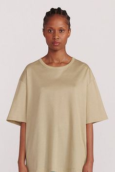 The oversized fit of this Cotton Tee presents a dynamic style in a sophisticated basic. Similar to silk knits we've seen, this cotton stands above the rest, elevated and somewhat shimmery. Expect a generous oversized fit from the size of your choice. DETAILS 100% mercerized cotton. Woven in Italy. Round collar. Straight sleeves with dropped shoulders. Oversized t-shirt. Machine wash at 30°C. Made in Poland. SIZE Diamy measures 5'8" and is wearing a size 1. Measurements: Chest 31.5 / Waist 23.5 / Knit Shoes, Silk Knit, Birthday Shopping, Childrens Gifts, Architecture Fashion, Oversized T Shirt, Blouse Dress, Oversized Tshirt, Round Collar