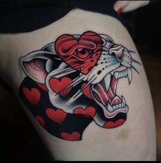 a woman's thigh with a tattoo on it and an image of a cat holding a heart