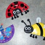 three paper ladybugs and one bee on the ground