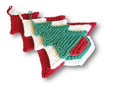 a crocheted christmas ornament hanging from a string on a white background