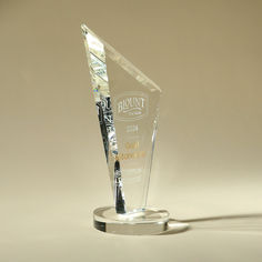 an award is placed on top of a glass base with a black and white design