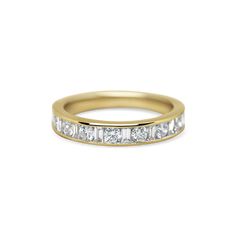 a yellow gold wedding band with princess cut diamonds on the side and channeled sides