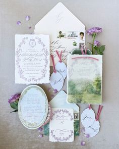 the wedding stationery is laid out on top of each other, including cards and envelopes