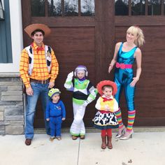 a family dressed up as toy story characters standing in front of a garage door for halloween