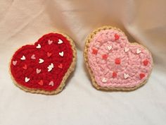 two crocheted hearts sitting next to each other