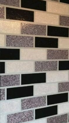 a white and black tiled wall in a bathroom