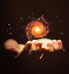 someone is holding their hand up in front of a spiral object with the words you are the universe expressing itself as a human for a little while