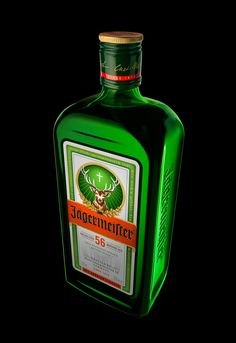 a bottle of green liquor sitting on top of a table