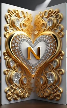 a card with the letter n on it and an intricate heart shaped design in gold