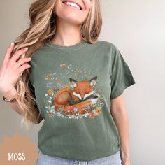 Sleeping Fox Cottagecore Shirt, Wildflowers and Fox T-Shirt, Soft Comfort Colors Crewneck T-Shirt, Gift for Nature Lover ☛ DESCRIPTION: --Made with medium weight fabric. --100% ring spun US cotton --Relaxed fit --Crew neckline --Pre-shrunk fabric. Check size chart for perfect size for you. ☛ PRODUCTION TIME: -- 2-3 business days ☛ SHIPPING TIME: -- 2-5 business days ☛ SIZING: --These shirts run true to size. --For a comfy fit (not oversized) I recommend going with your regular size. For a slightly looser fit go up a size and for the oversize look I'd recommend to size up 2 to 3 sizes. Image designed using AI technology.  ☛ For more shirt designs please visit my store at: https://mayasdesignsco.etsy.com Fox Cottagecore, Cottagecore Shirt, Gifts For Nature Lovers, Comfy Fits, Image Design, Nature Lover, Medium Weight, Comfort Colors, Crew Neckline