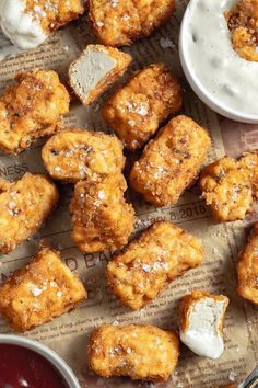 fried chicken nuggets with ranch dip and sour cream on the side, ready to be eaten