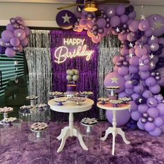 a birthday party with purple balloons and desserts