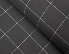 a black and white checkered fabric with some white stitching on the side,