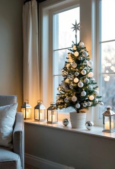 a small christmas tree sitting on top of a window sill