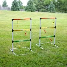 three different colored balls are in the air on an outdoor game set that is made out of metal pipes