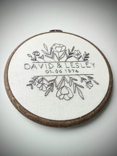 the embroidery on this hoop is embroidered with flowers and leaves