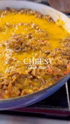 a casserole dish with cheese and meat in it sitting on the stove top