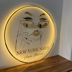 a neon sign with a woman's face and words on it that read new york nails simply glamour