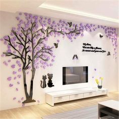 a living room with white walls and purple trees on the wall