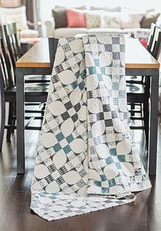 a black and white checkered blanket sitting on top of a wooden table