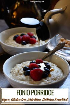 two white bowls filled with oatmeal and berries