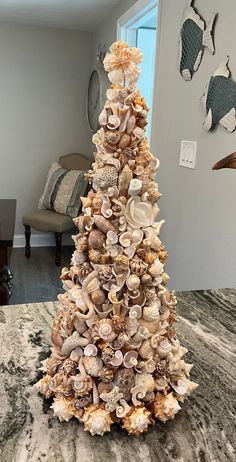 a christmas tree made out of seashells in a living room