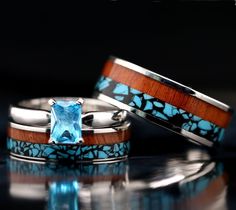 two wedding rings with blue and brown wood inlays, set on top of each other