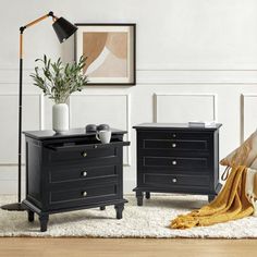 two black nightstands sitting on top of a white rug