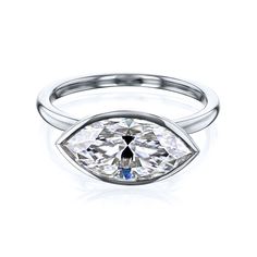 a white gold ring with an oval cut diamond