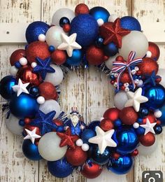 a patriotic wreath with red, white and blue ornaments