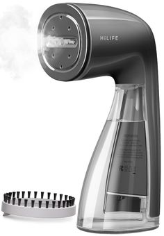 an electric hair dryer is shown next to a comb and brush holder with steam coming out of it