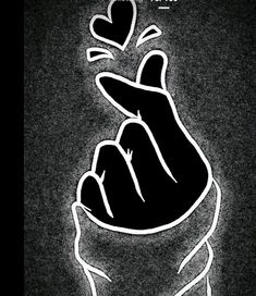 a black and white drawing of a hand holding a heart