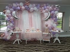 a table with balloons and cake on it