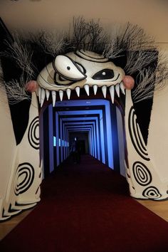 the hallway is decorated in white and black with an animal head on it's face