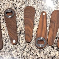 four wooden kitchen utensils lined up on a counter