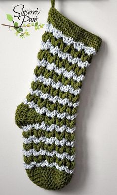 a crocheted christmas stocking hanging from a hook on a wall with the words,