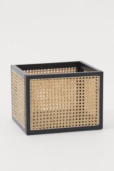 a black and rattan basket on a white background