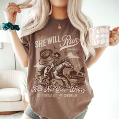 ✨"She Will Run and Not Grow Weary"✨ Unleash your inner cowgirl with our "She Will Run and Not Grow Weary" t-shirt, inspired by Isaiah 40:31. This bold design features a dynamic cowgirl on horseback, symbolizing resilience and faith. Perfect for anyone who loves western themes and inspirational messages, this tee is a stylish reminder to keep your faith strong and your spirit unbroken. Tags: #CowgirlFaith #WesternApparel #InspirationalTee #BibleVerseShirt #ChristianClothing #Isaiah4031 #FaithFashion #CowgirlUp #ResilientSpirit #ReligiousTshirt #CowgirlLife #ChristianGifts #MotivationalWear Comfort Colors ＦＡＢＲＩＣＡＴＩＯＮ ＆ ＰＲＩＮＴＩＮＧ ✿ Please note: The colors of the text, design, and/or shirt may vary slightly from the photo shown, due to lighting, printing, or computer and phone screens. ✿ 100% r Cheap Graphic Print Tops For Western-themed Events, Western Cricut Tshirts, Casual Shirt With Digital Print, Cute Cricut Shirts Western, Western Shirts Vinyl Bohemian, Horse Cricut Shirts, Cowgirl Style Outfits Casual, Western Women Outfits, Country Boho Outfit