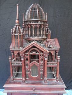 an old wooden model of a building with many windows and arches on the top floor