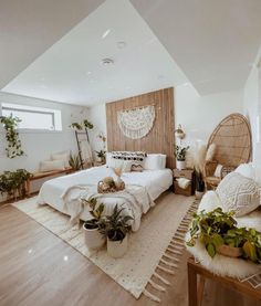 a bed room with a neatly made bed and lots of plants