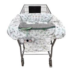 a shopping cart with a baby in it and a laptop computer on top of it