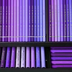 several rows of purple colored pencils on display