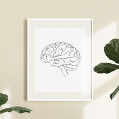 a black and white drawing of a brain on a wall next to a potted plant