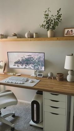 a desk with a computer on top of it and a chair in front of it