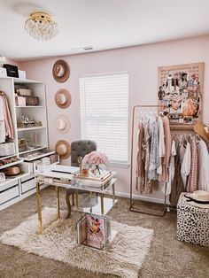 a room with pink walls and white furniture