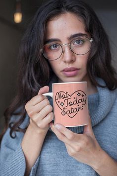 a woman wearing glasses holding up a mug with the words,'auntie i love you